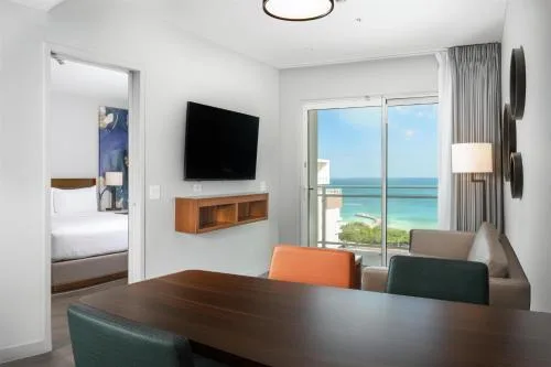 Oceanview one-bedroom suite living area and bedroom at Embassy Suites Aruba Beach Resort.