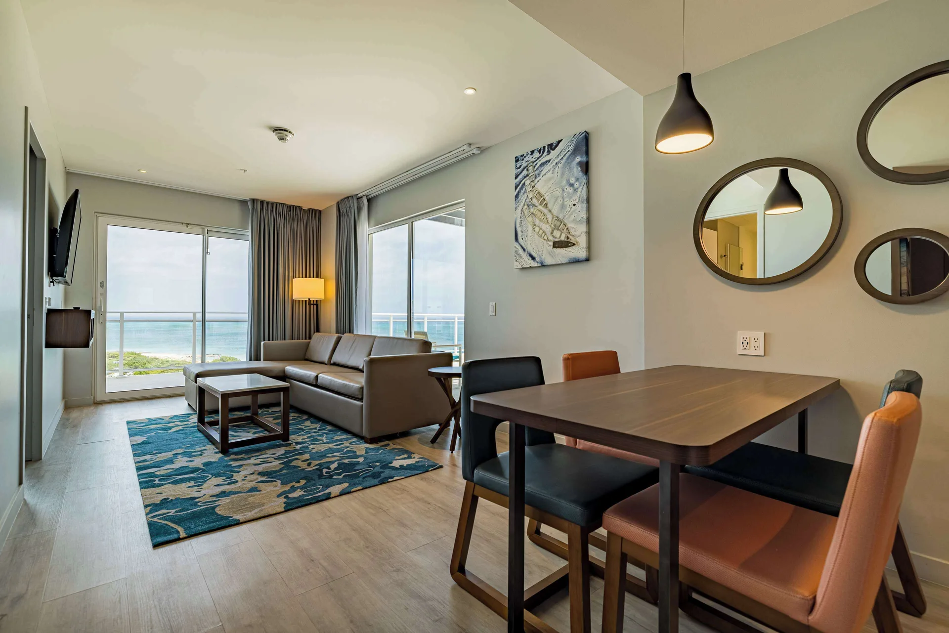 Oceanfront suite living and dining area at Embassy Suites Aruba Beach Resort.