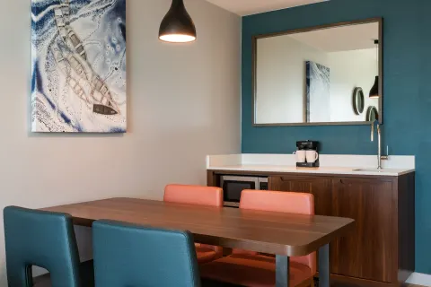 Dining table and wet bar in a suite at Embassy Suites Aruba Beach Resort.