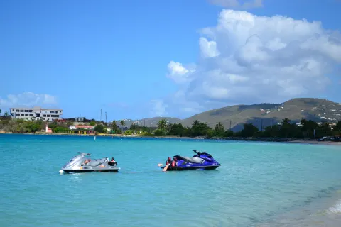 Personal watercraft float near the shoreline at Emerald Beach Resort.