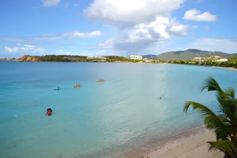Turquoise bay with kayaks and shoreline near Emerald Beach Resort.