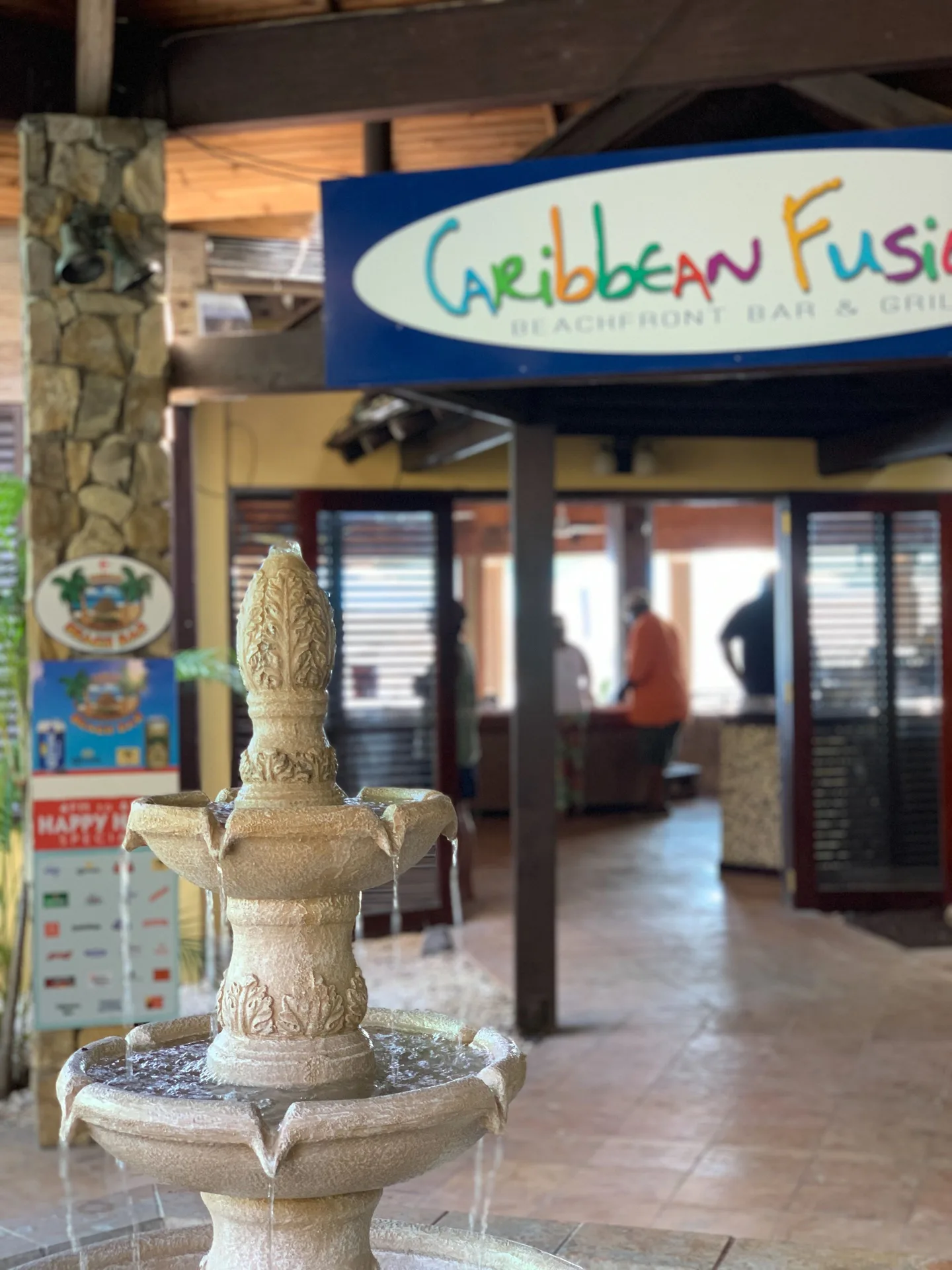 Caribbean Fusion entrance sign and fountain at Emerald Beach Resort.