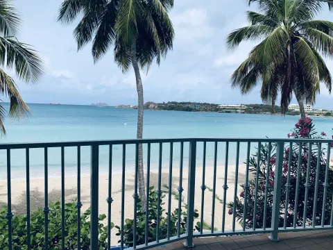 Beachfront Premium Bed Room balcony view of beach and palms at Emerald Beach Resort.