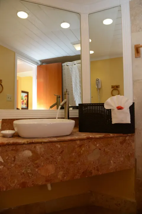 Bathroom vanity with vessel sink and mirror at Emerald Beach Resort.