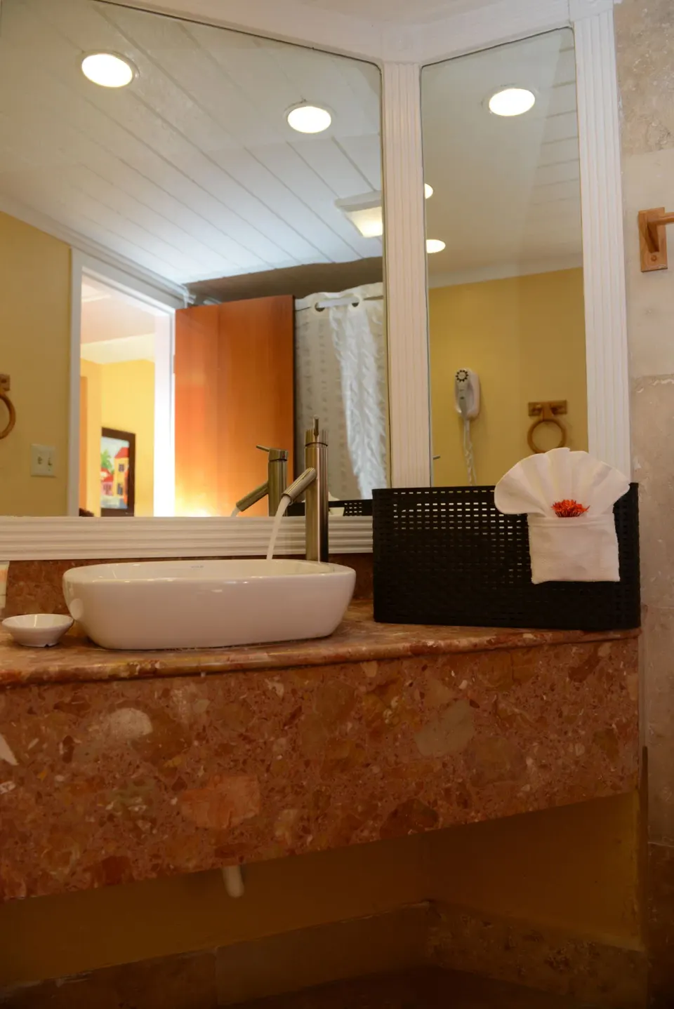 Bathroom vanity with vessel sink and mirror at Emerald Beach Resort.