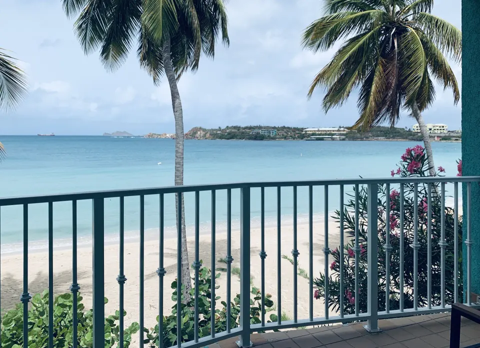 Beachfront Premium Bed Room balcony view with palms and shoreline at Emerald Beach Resort.