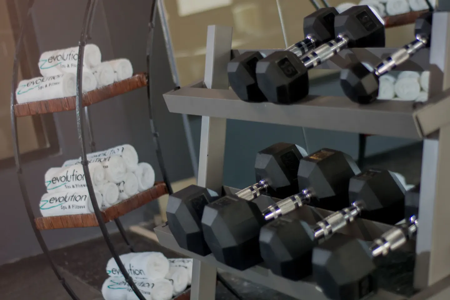 Dumbbell rack and rolled towels in the fitness room at Emotions by Hodelpa Puerto Plata.