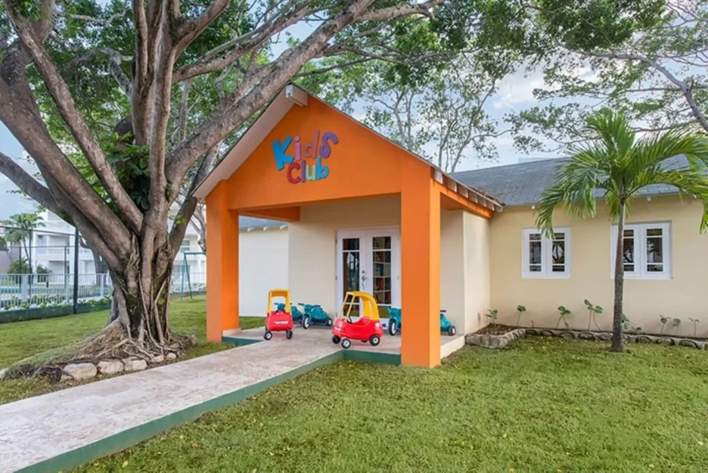 Kids club entrance with toy cars outside at Emotions by Hodelpa Puerto Plata.