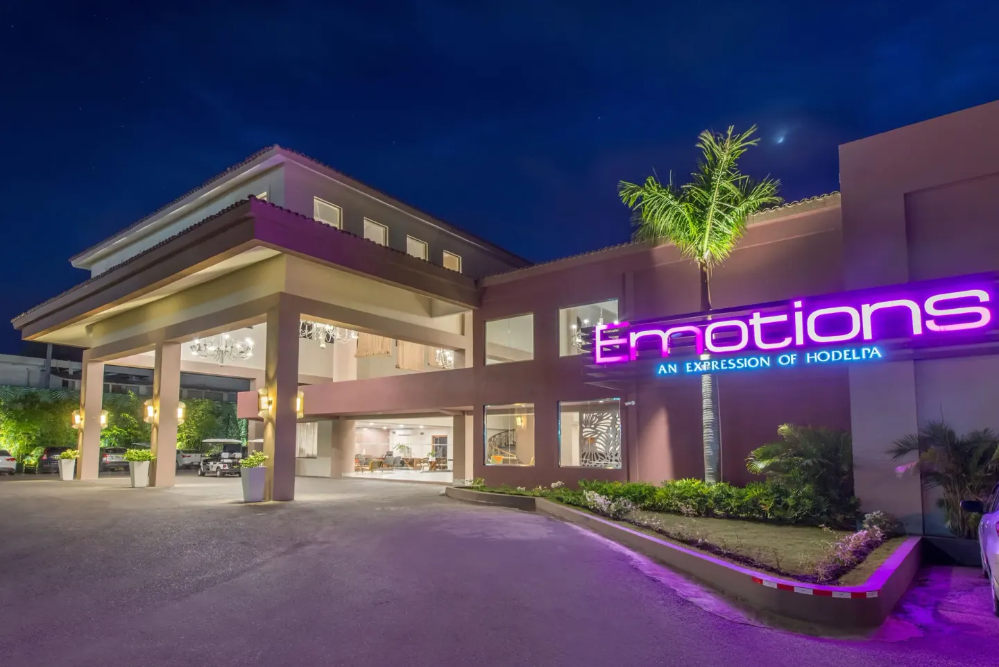 Nighttime entrance with illuminated hotel sign at Emotions by Hodelpa Puerto Plata.