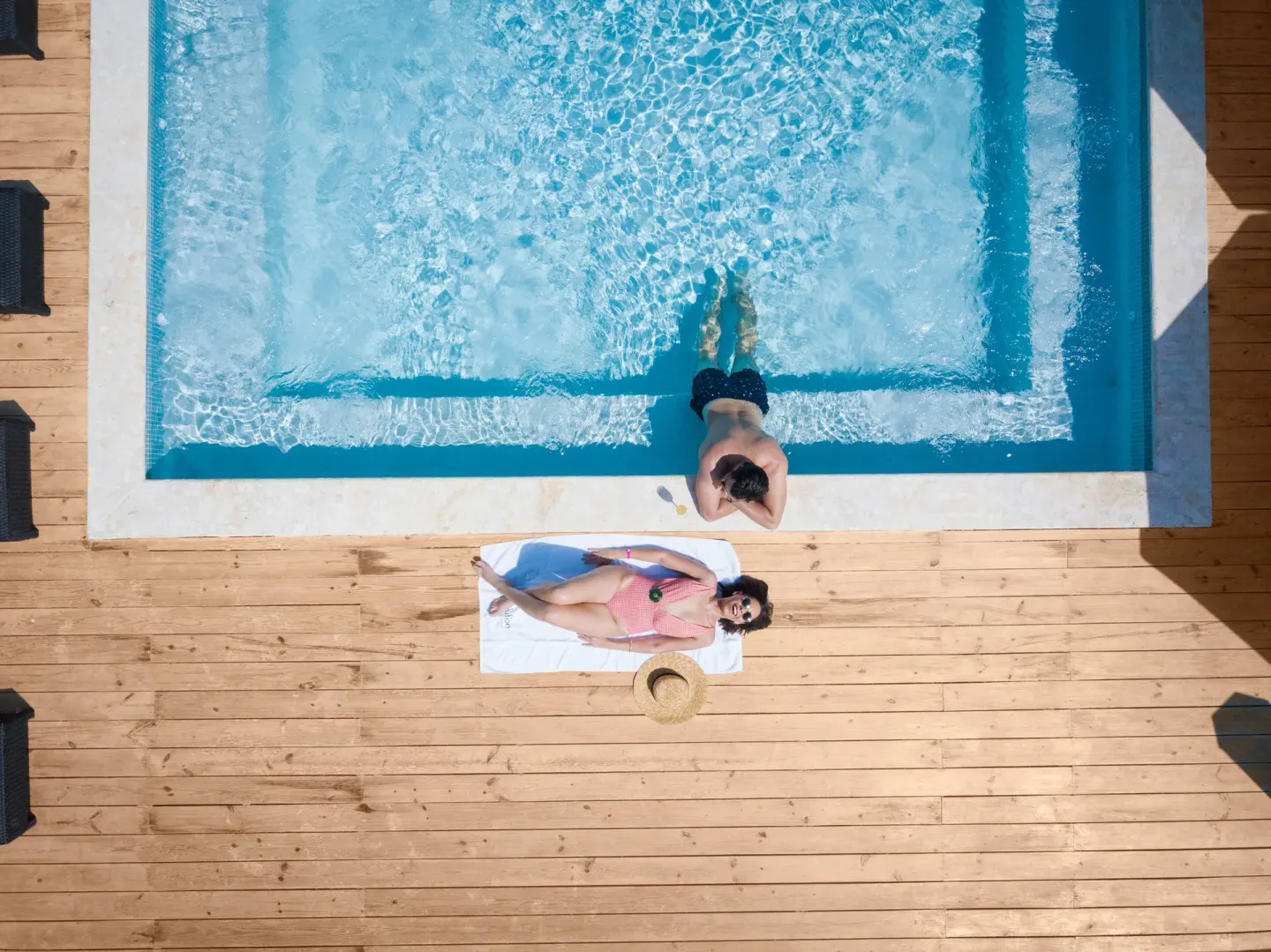 Overhead view of a pool deck and guest in the water at Emotions by Hodelpa Puerto Plata.