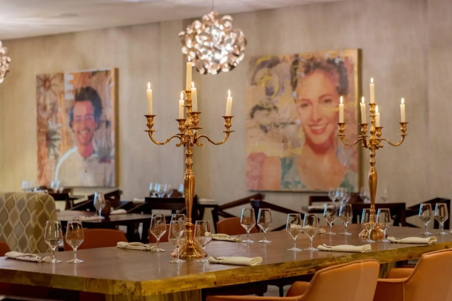 Restaurant table with candelabras and portrait art at Emotions by Hodelpa Puerto Plata.
