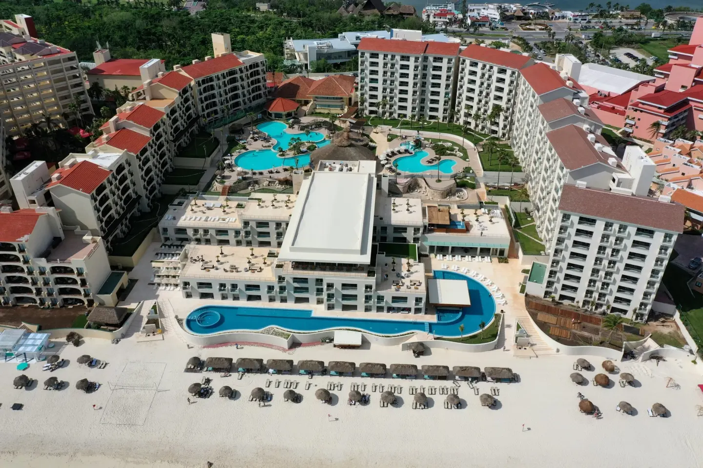 Aerial view of pools, beach, terraces, and resort buildings at Emporio Cancun.