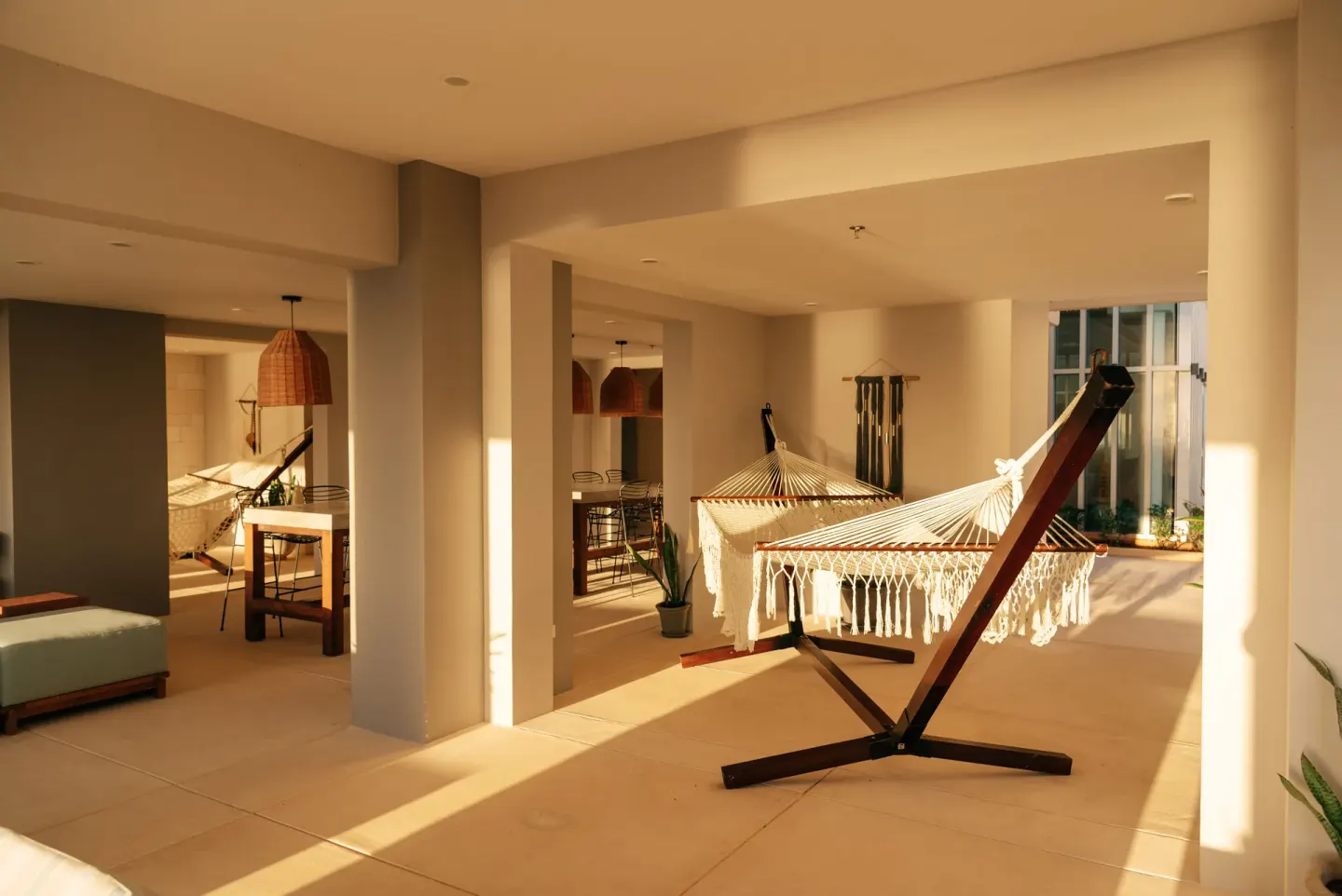 Hammock lounge with warm sunlight and seating at Emporio Cancun.