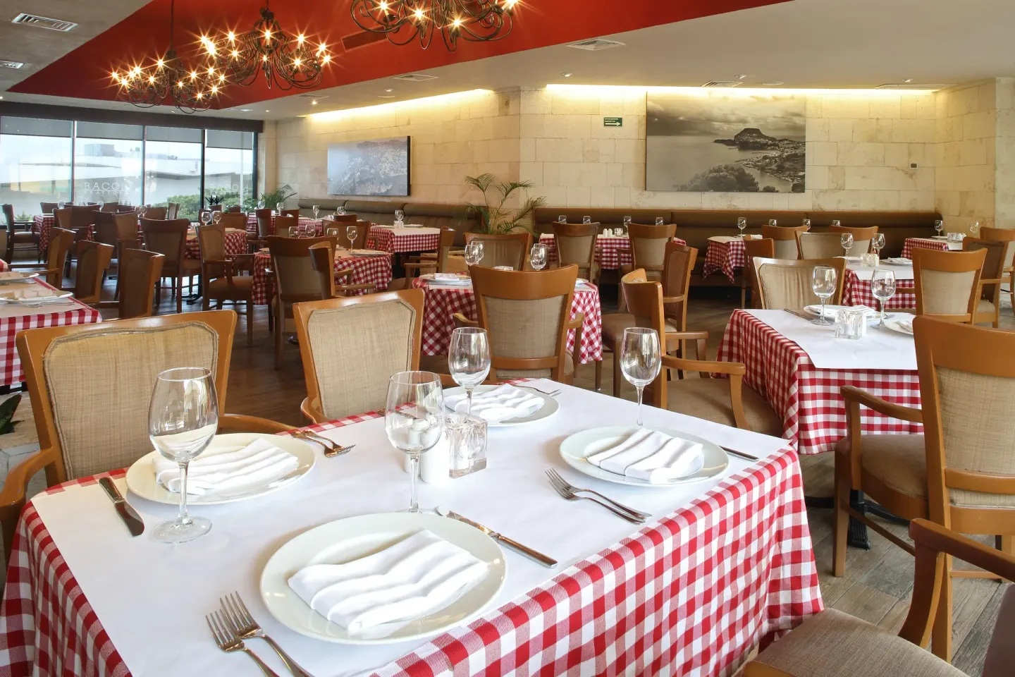 Italian-style dining room with checkered tablecloths at Emporio Cancun.