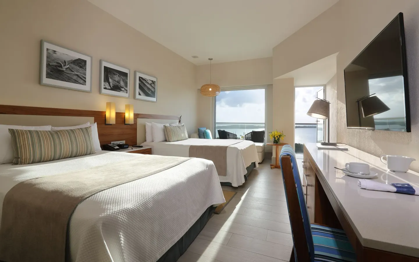 Deluxe Doble Room Oceanfront with two beds and ocean-facing balcony at Emporio Cancun.