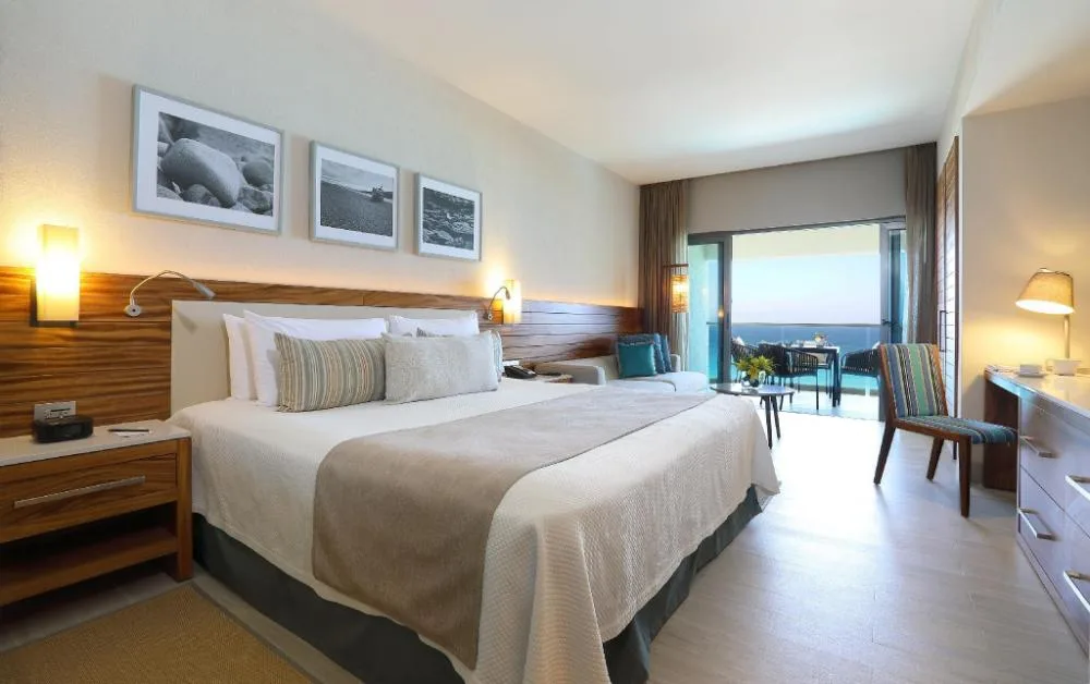 Partial Sea View Room with king bed and balcony at Emporio Cancun.