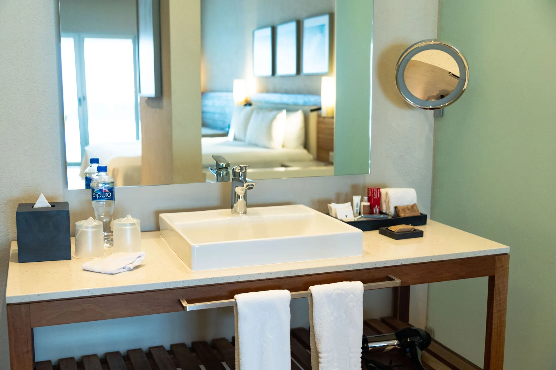 Master Suite Oceanfront at Emporio Cancun with vanity area and bed reflection showcasing elegant design and oceanfront ambiance.