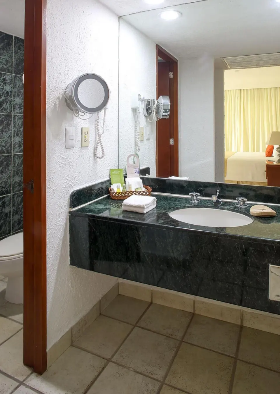 Guest bathroom vanity with mirror and sink at Emporio Ixtapa.