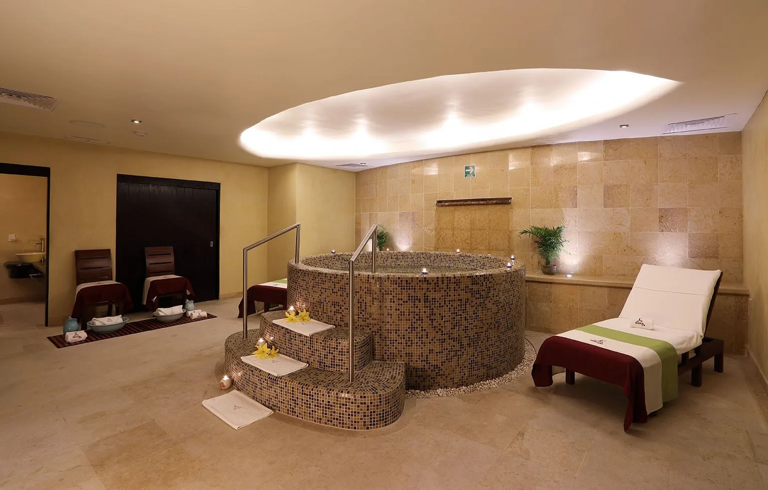 Spa hydrotherapy tub and loungers in a tiled treatment room at Emporio Ixtapa.