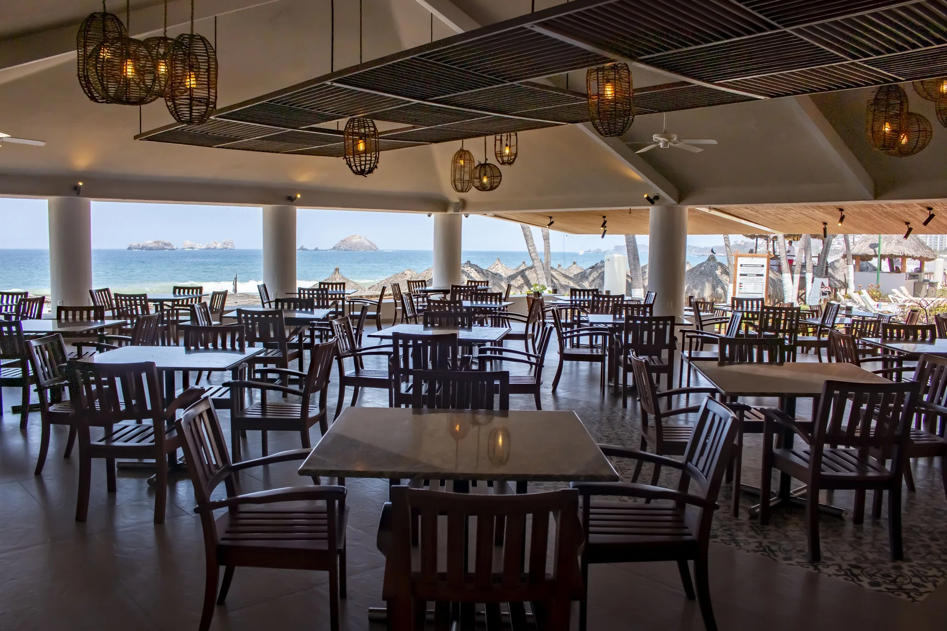 Open-air beachfront dining room with ocean views at Emporio Ixtapa.