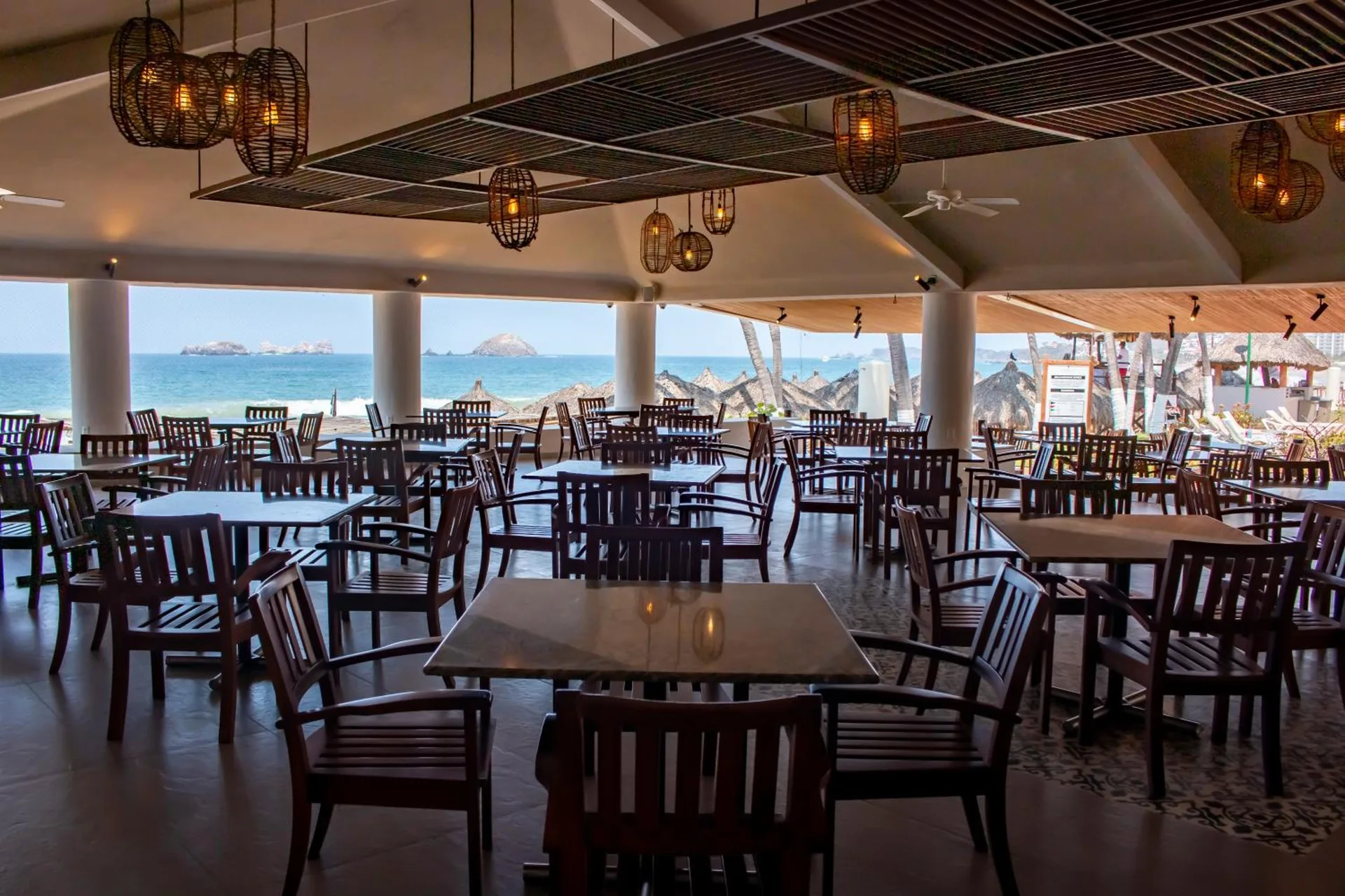Open-air beachfront dining room with ocean views at Emporio Ixtapa.