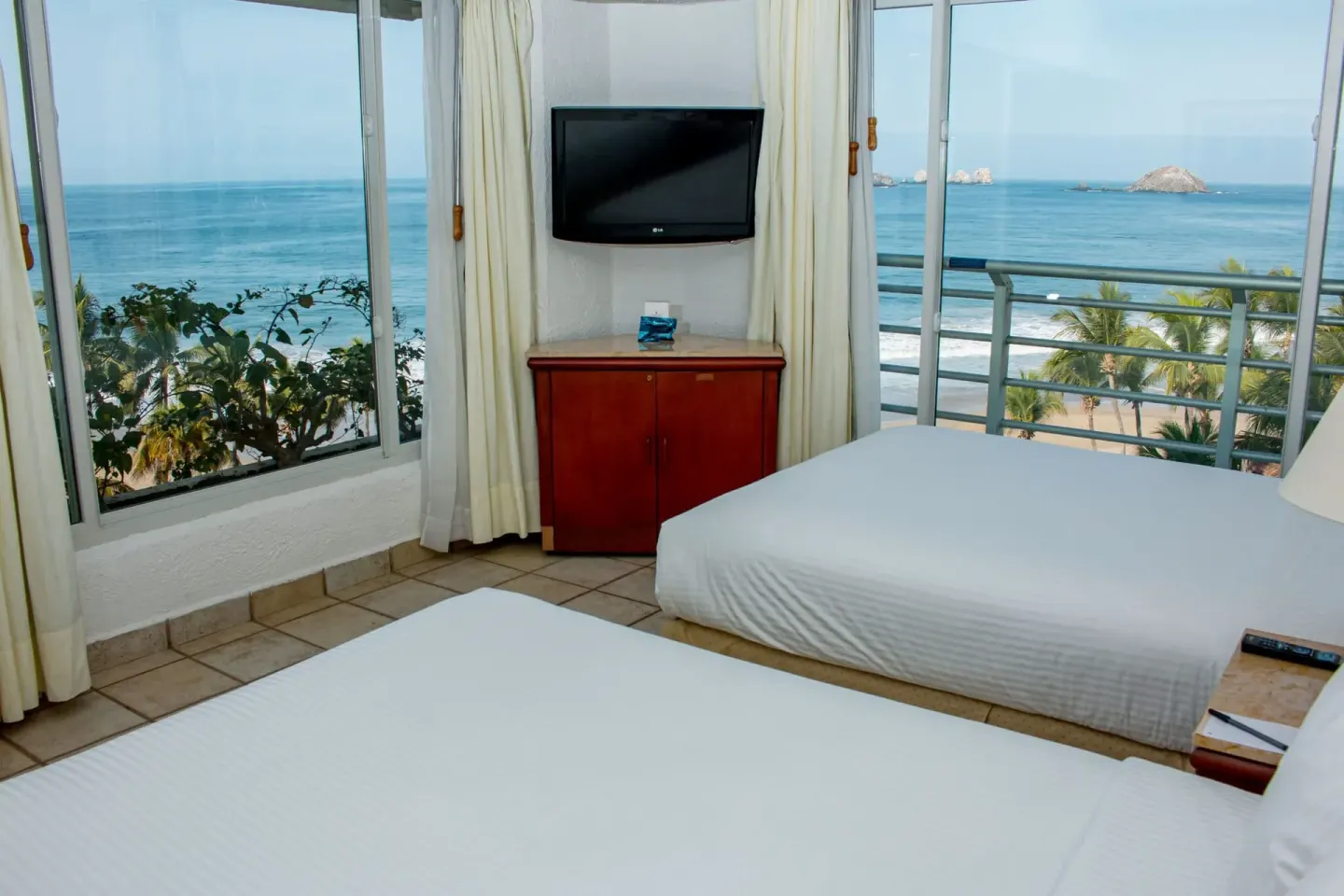Junior Suite Ocean View two beds with balcony and ocean backdrop at Emporio Ixtapa.
