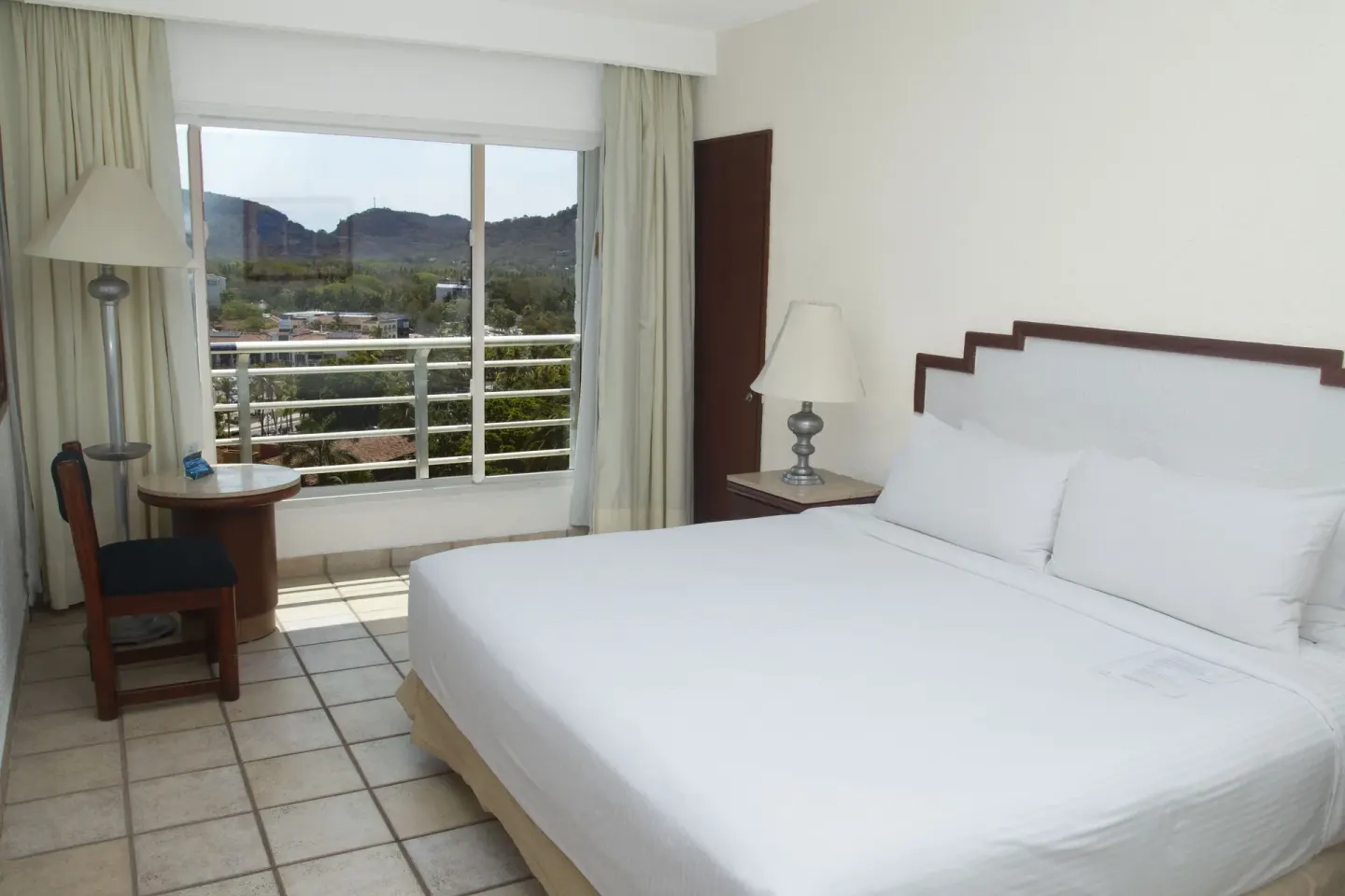 Superior Mountain View room with king bed and balcony at Emporio Ixtapa.