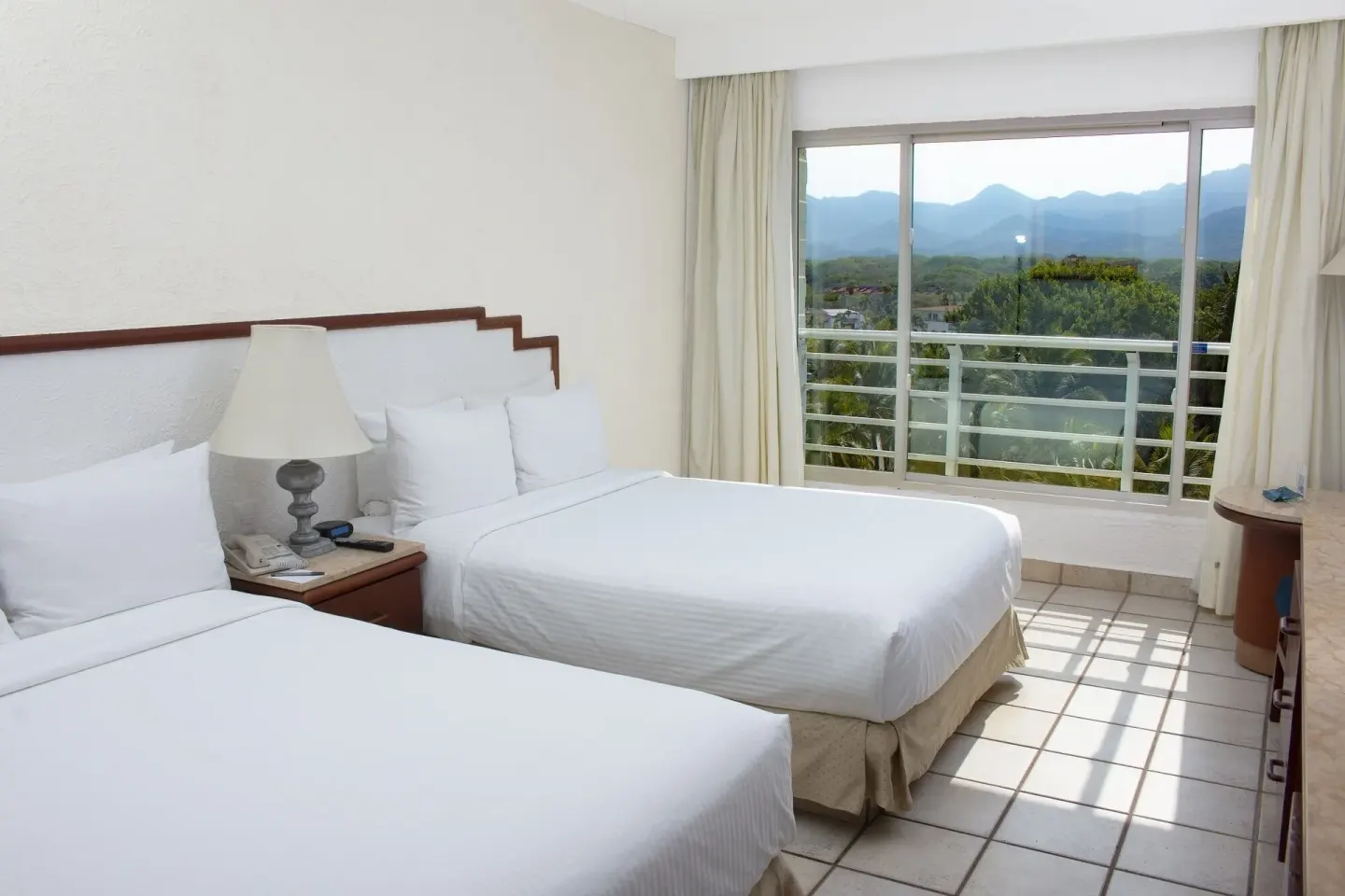 Superior Mountain View room with two beds and mountain-facing windows at Emporio Ixtapa.