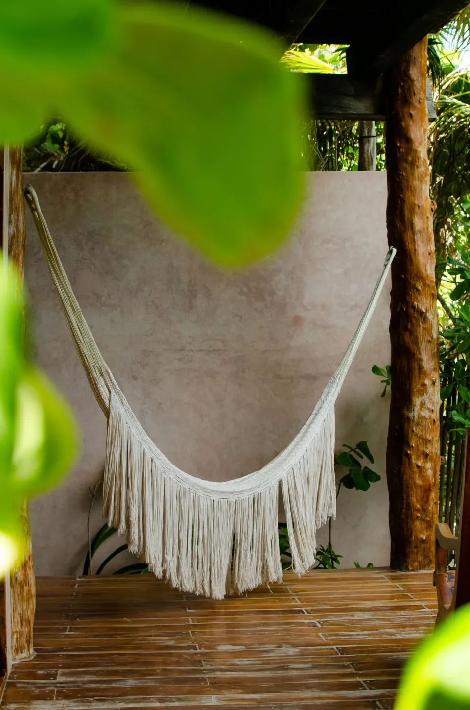 White fringed hammock on a shaded private terrace at Encantada Tulum