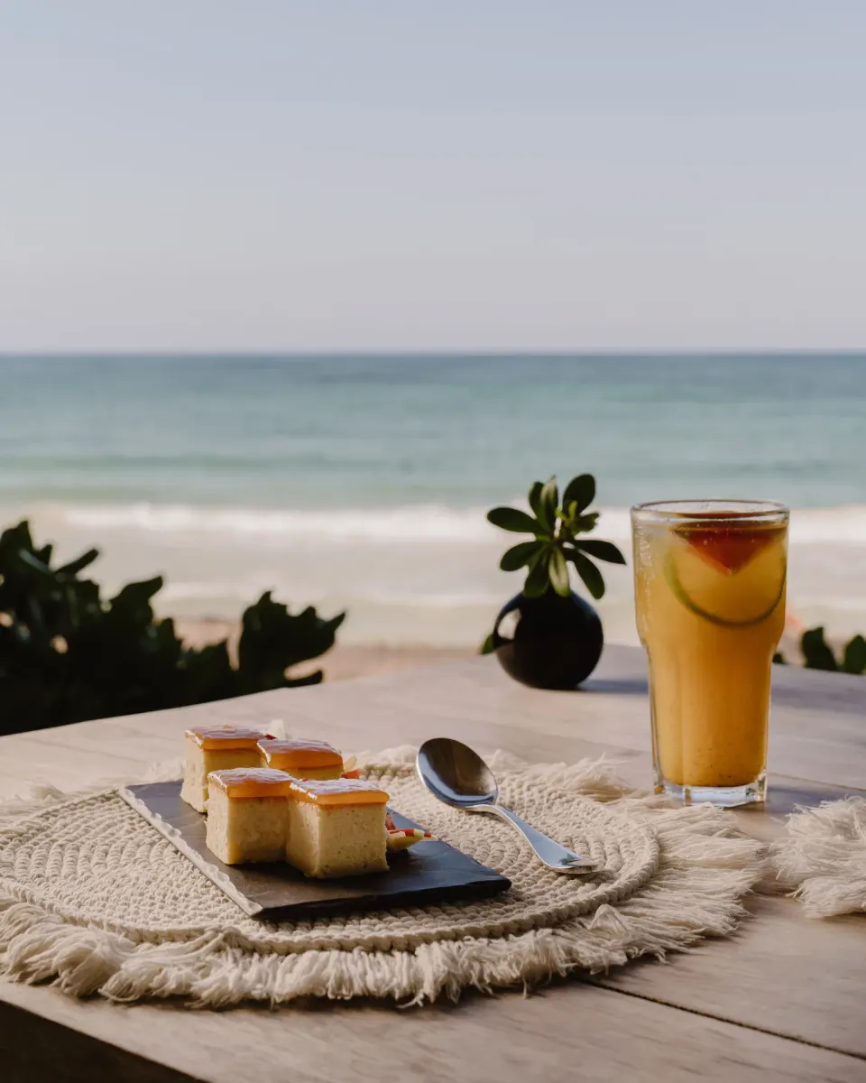 Dessert and a cold drink on a table with ocean view at Encantada Tulum