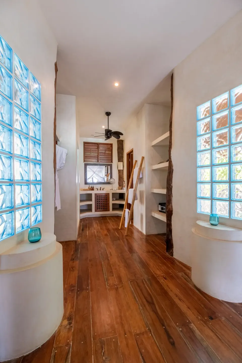 Hallway to bathroom with glass-block windows in the Beach Front Upper Room at Encantada Tulum