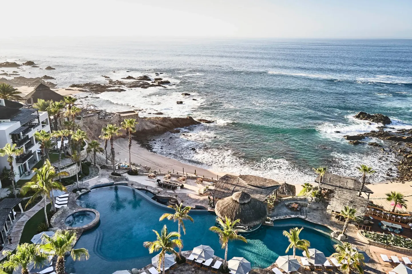 Aerial view of pools, beach and rocky coastline at Esperanza.