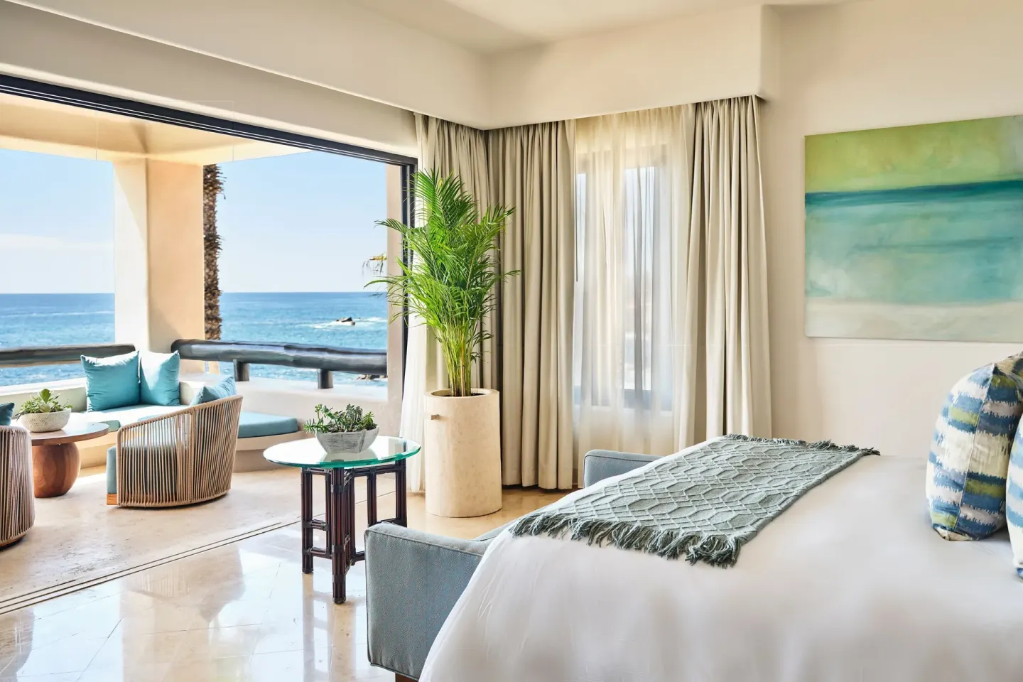Guest room with king bed and open ocean-view terrace at Esperanza.