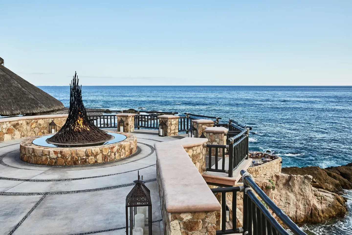 Oceanfront stone terrace with fire feature at Esperanza.