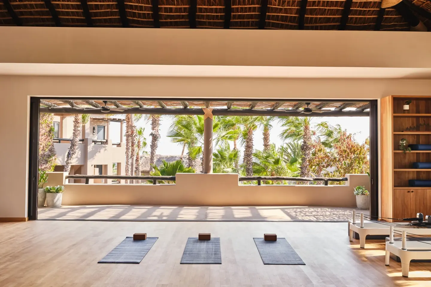 Open-air yoga studio with mats facing palms at Esperanza.