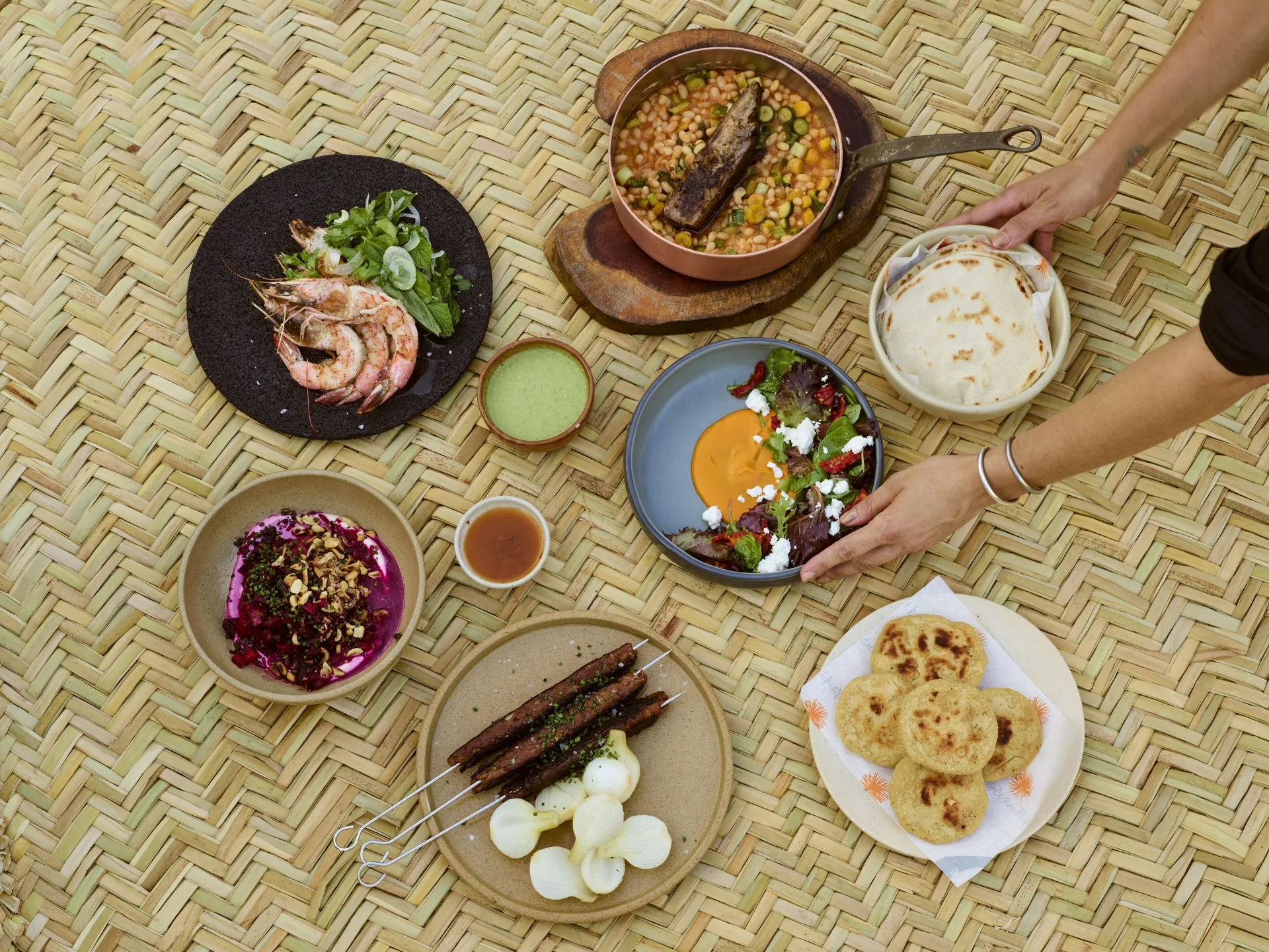 Overhead spread of plated Mexican dishes and tortillas at Esperanza.