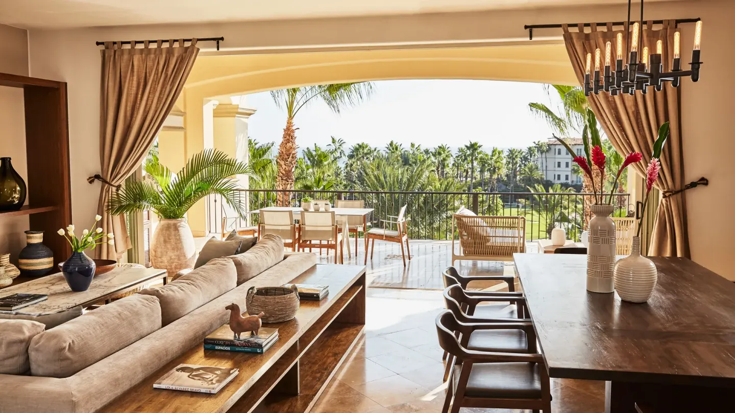 Casona living room with dining table, sofa, and wide terrace opening at Esperanza.