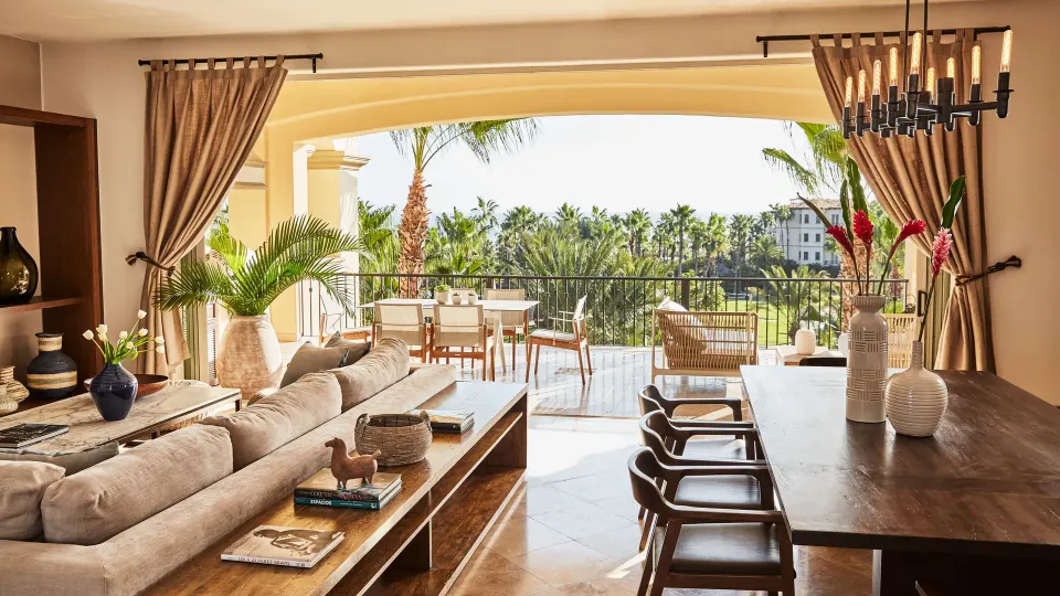 Casona living room with dining table, sofa, and wide terrace opening at Esperanza.