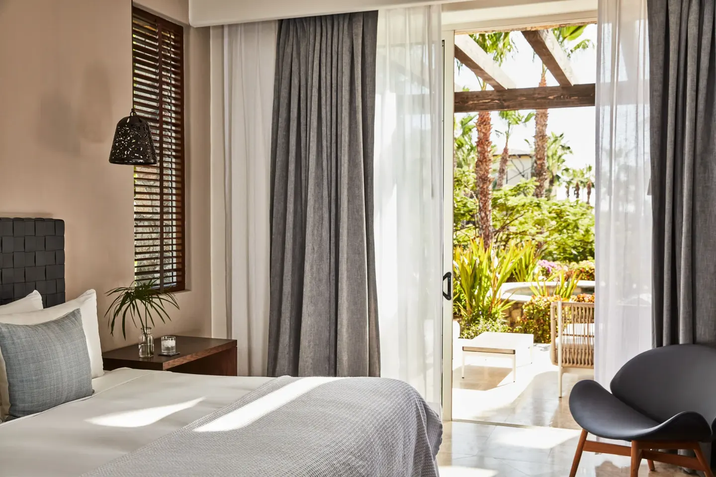Bedroom opening to a garden terrace in a three-bedroom ocean view casona at Esperanza.