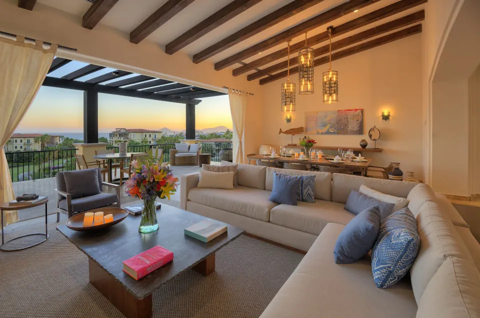 Casona living room with sectional sofa, dining table, and terrace at Esperanza.