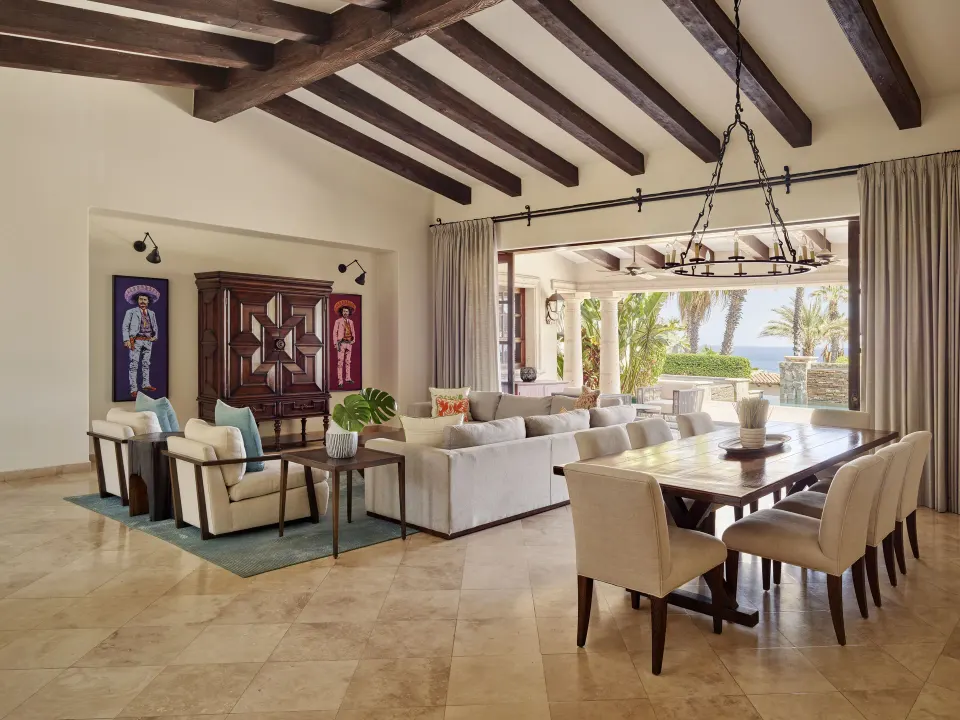 Living and dining room opening to an ocean-facing terrace at Esperanza.