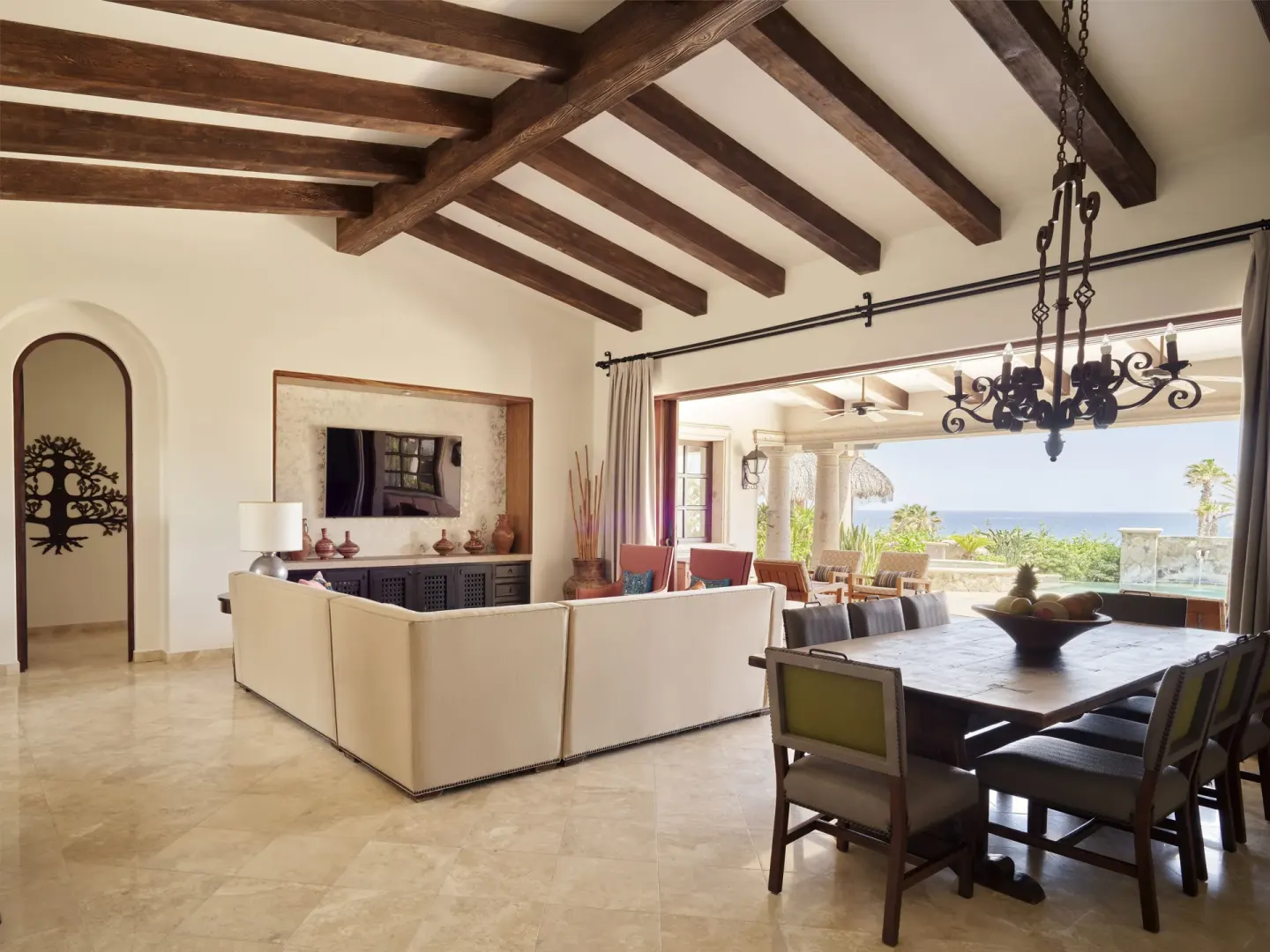 Living room and dining table with terrace and ocean view at Esperanza.