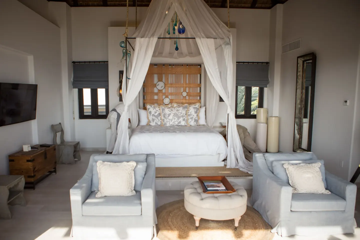 Penthouse Spa Suite canopy bed with two lounge chairs at Esperanza.