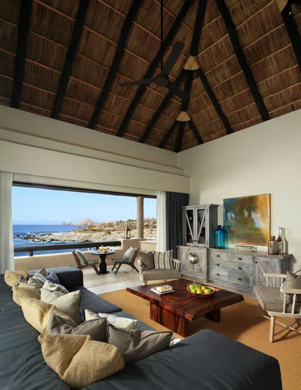 Penthouse Spa Suite living room with thatched ceiling and ocean view at Esperanza.