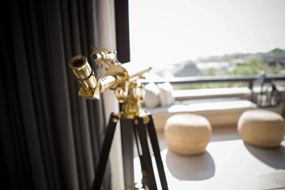 Brass telescope beside the ocean-view terrace of a Penthouse Spa Suite at Esperanza.