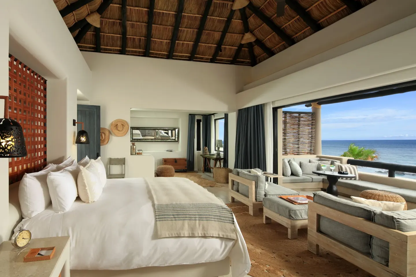 Oceanfront villa bedroom with king bed and seating area at Esperanza.