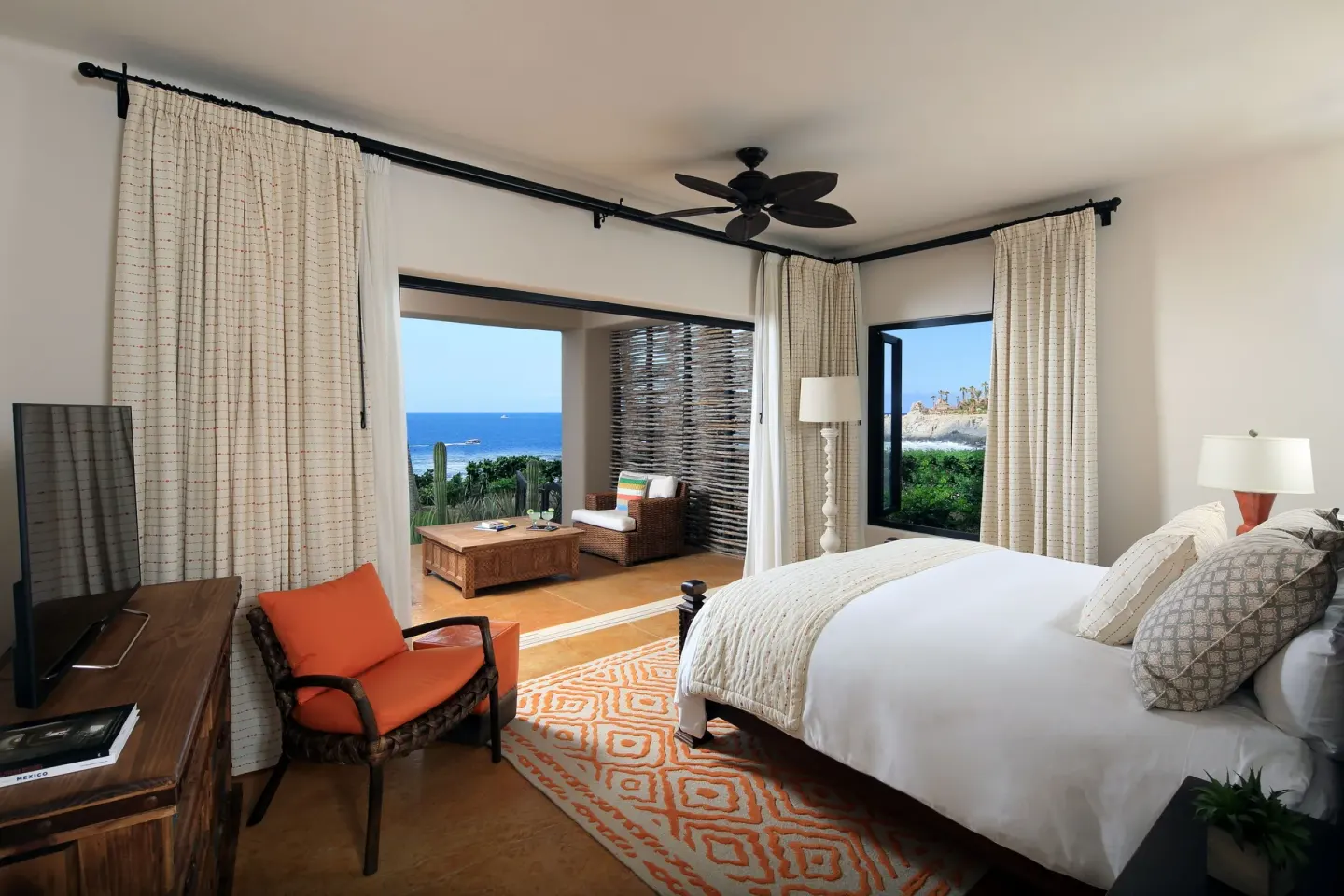 Villa bedroom with king bed, TV, and ocean-facing terrace at Esperanza.