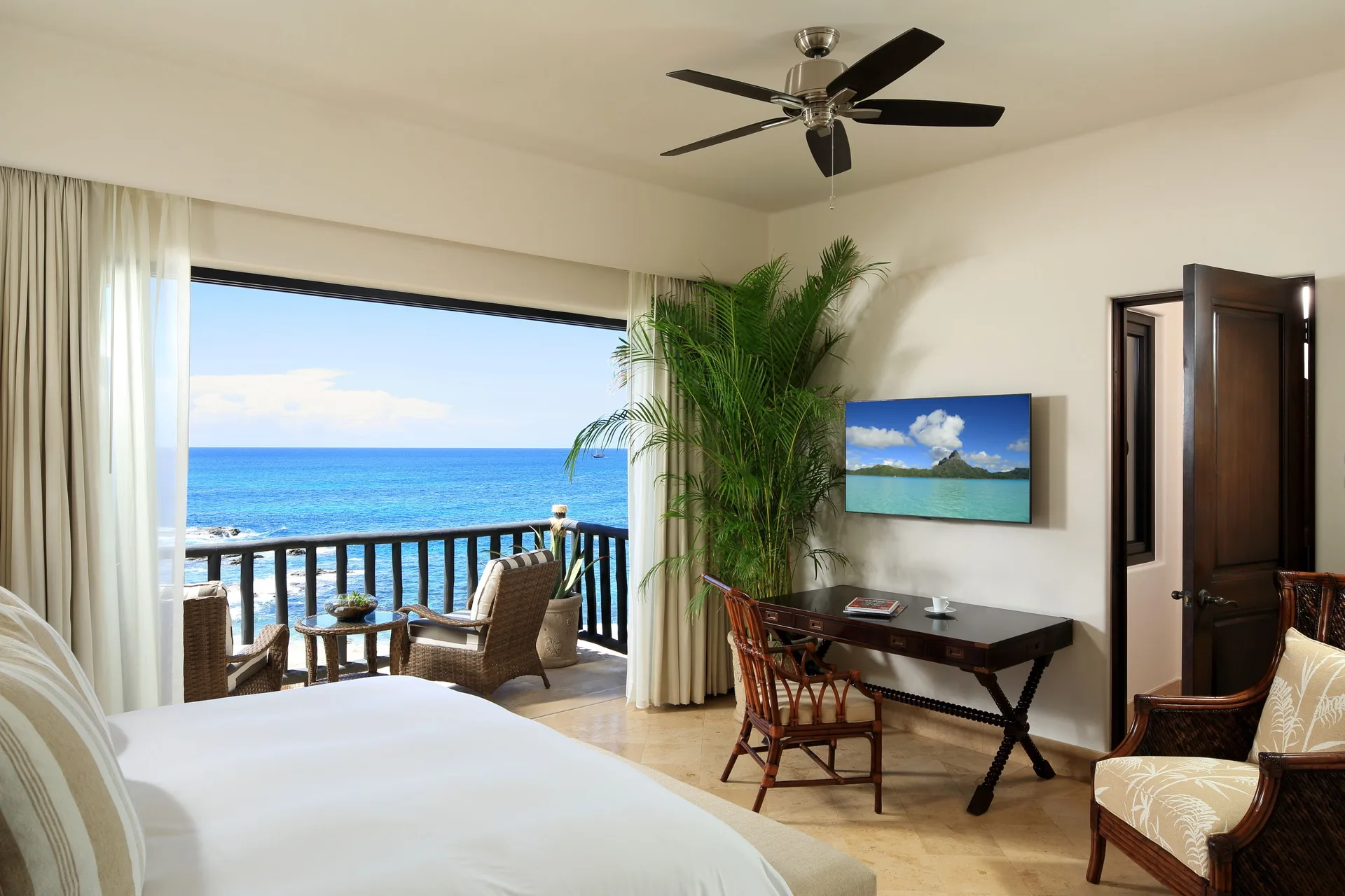 Oceanfront villa bedroom with balcony seating and sea view at Esperanza.