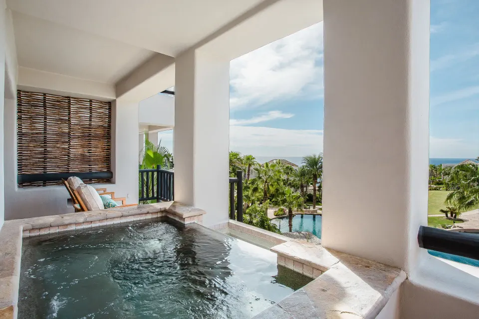 Plunge pool on a villa terrace with palms and ocean beyond at Esperanza.