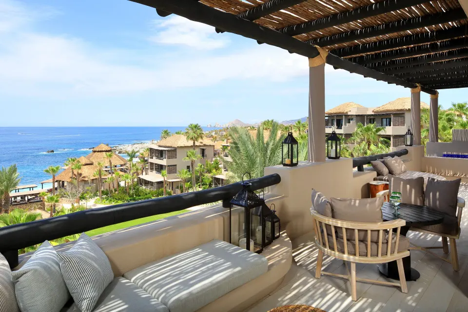 Ocean-view terrace seating with cushioned chairs and a daybed at Esperanza.